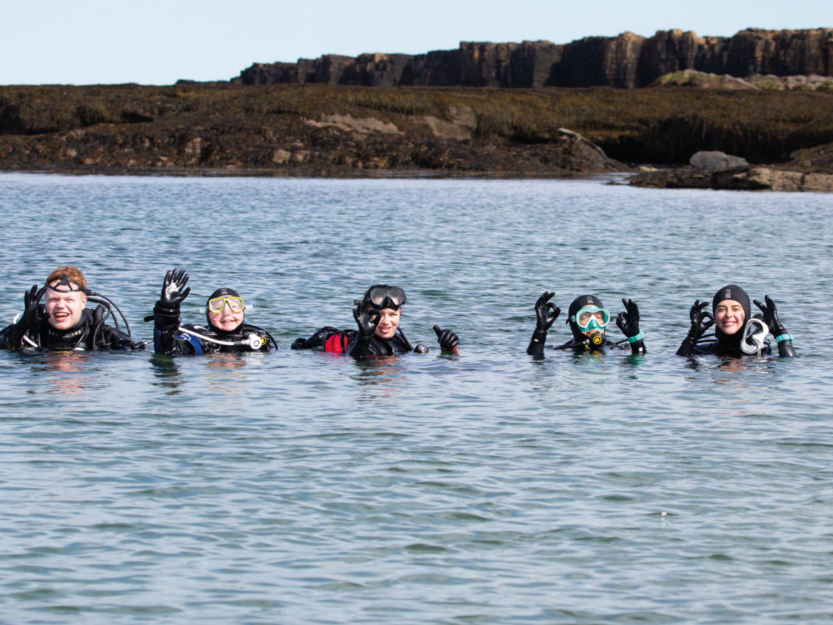 Dive pro with a group of divers in UK waters