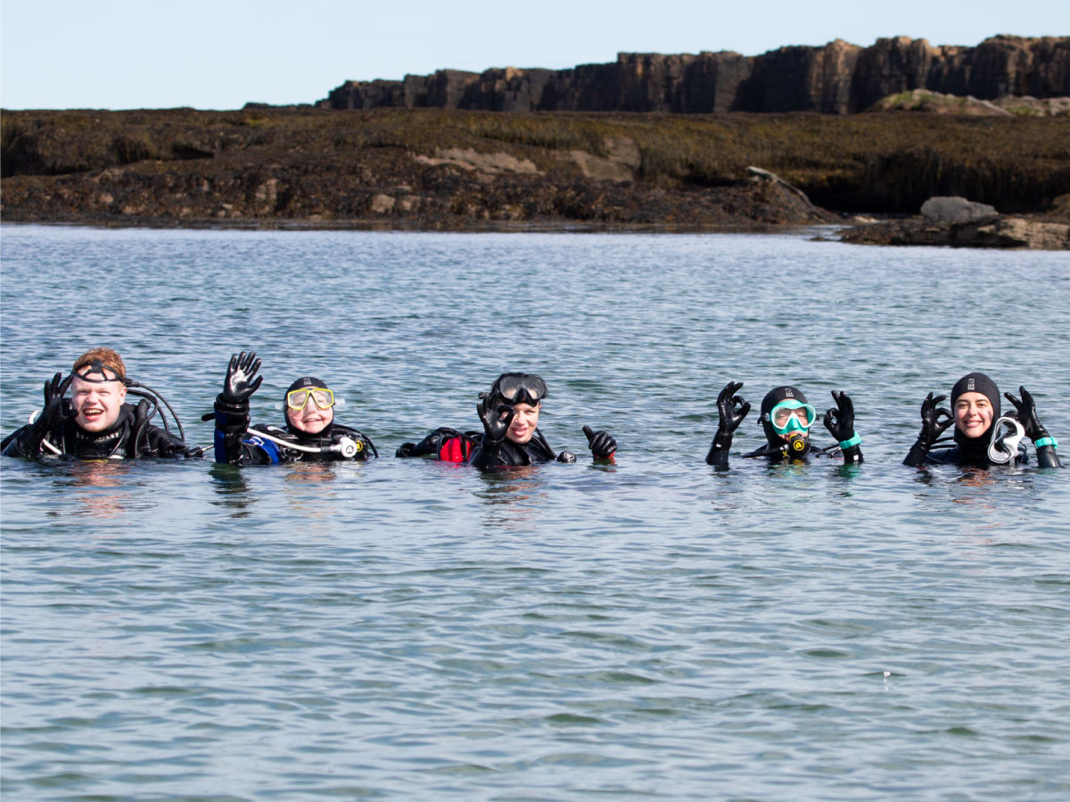 Divers in the water with their PADI Specialty Instructor